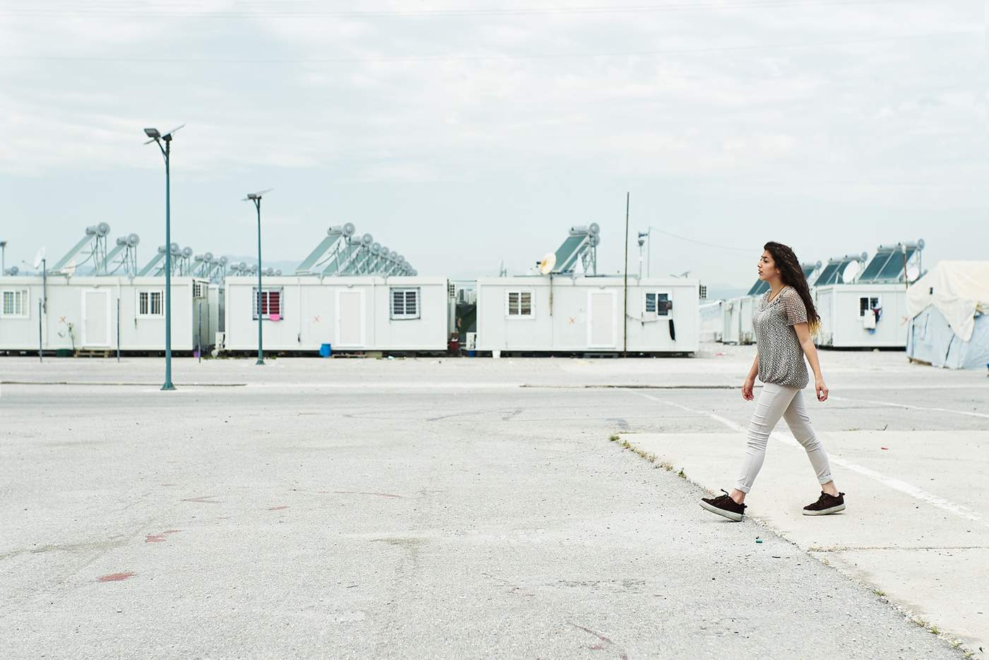 A teenager walking across the camp.