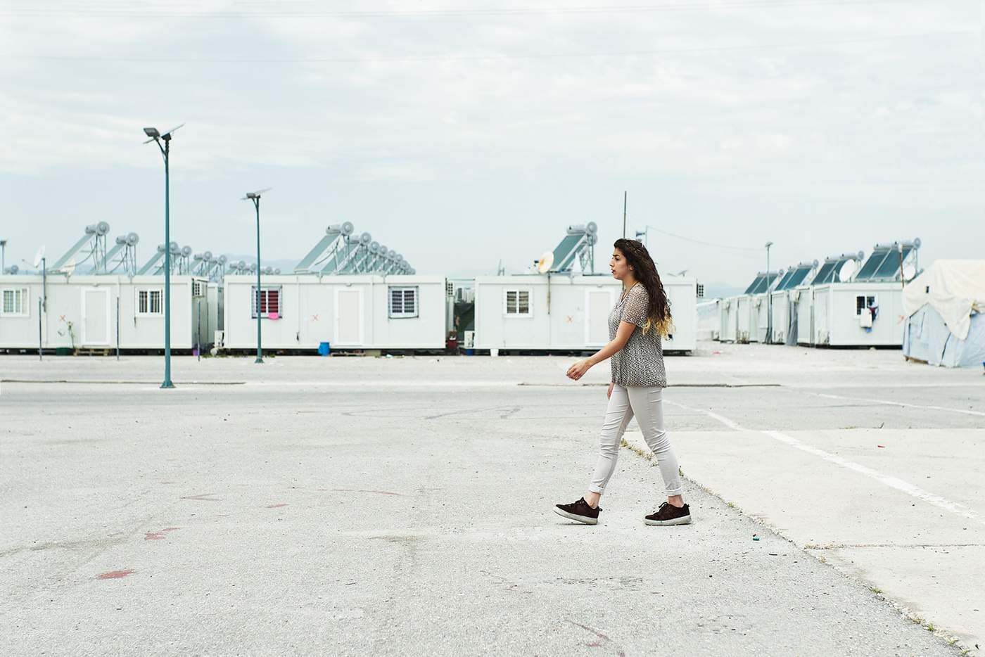 A teenager walking across the camp.