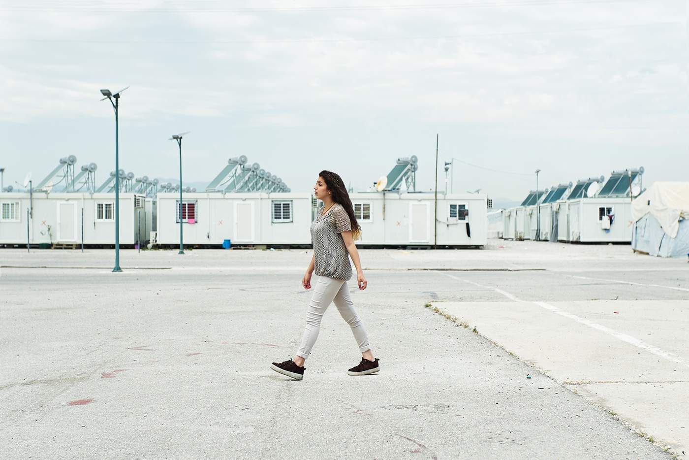 A teenager walking across the camp.