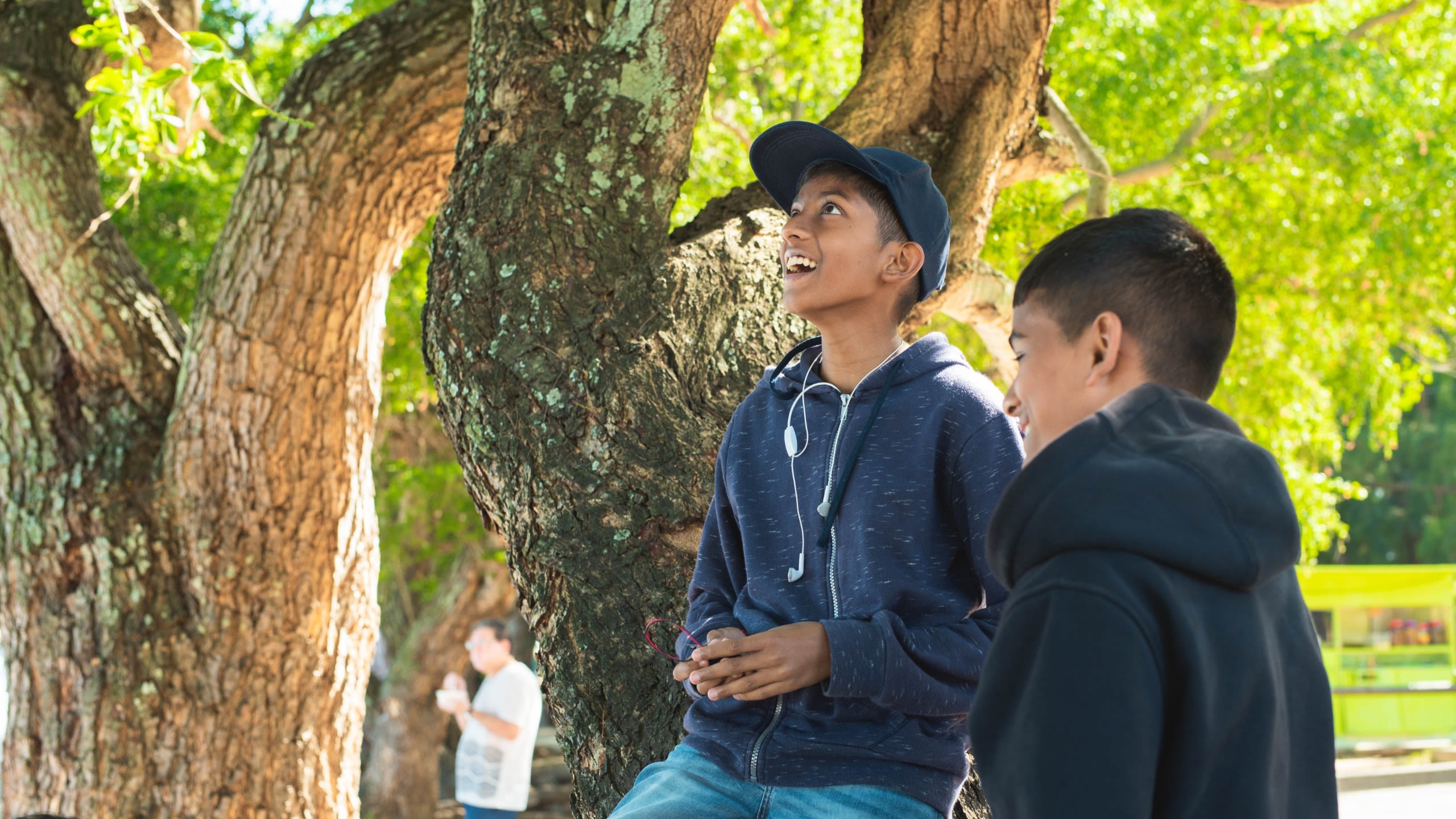 Mandeep climbing a tree to test out his micro:bit device.