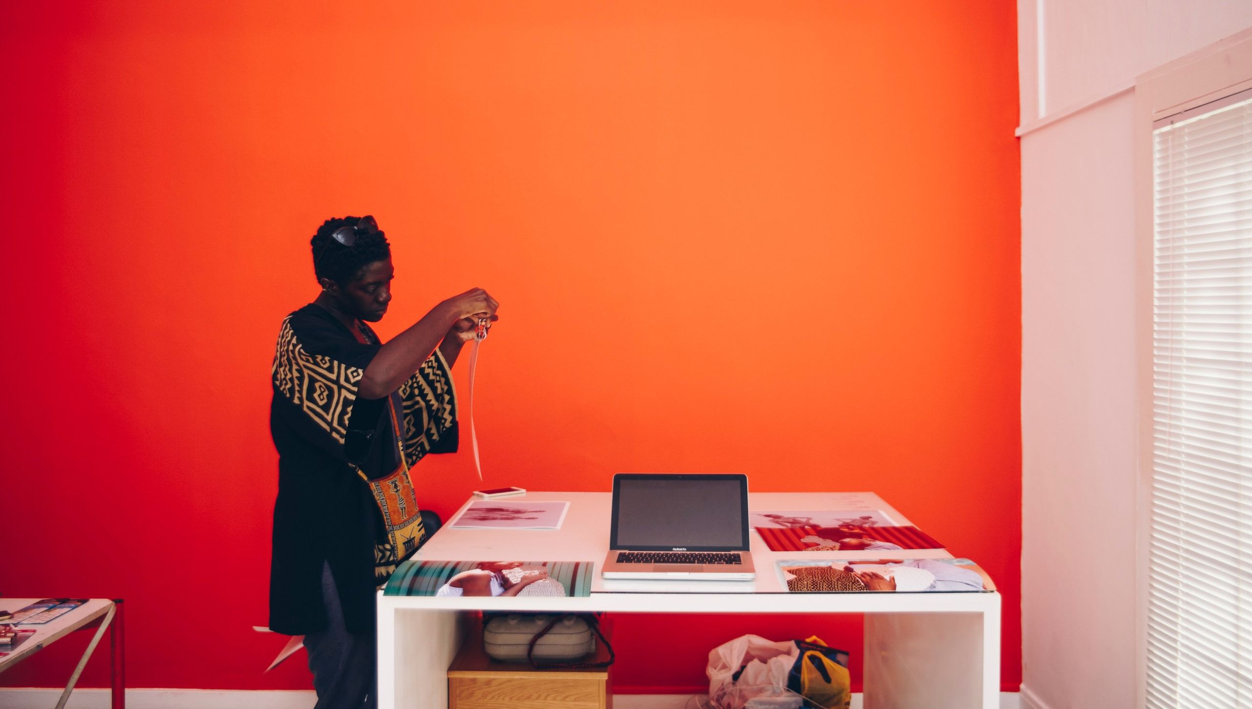 Behind the scenes shot of artist Keren putting together her exhibition piece at her desk